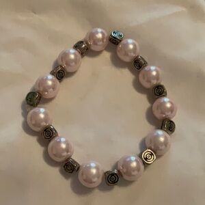 Pink pearl like and silver tone bracelet